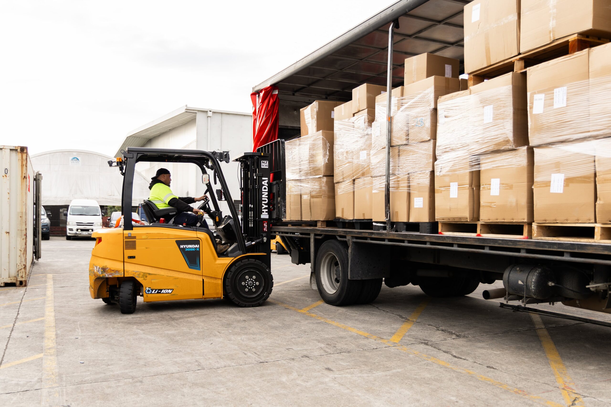 Forklift lifting boxes on truck