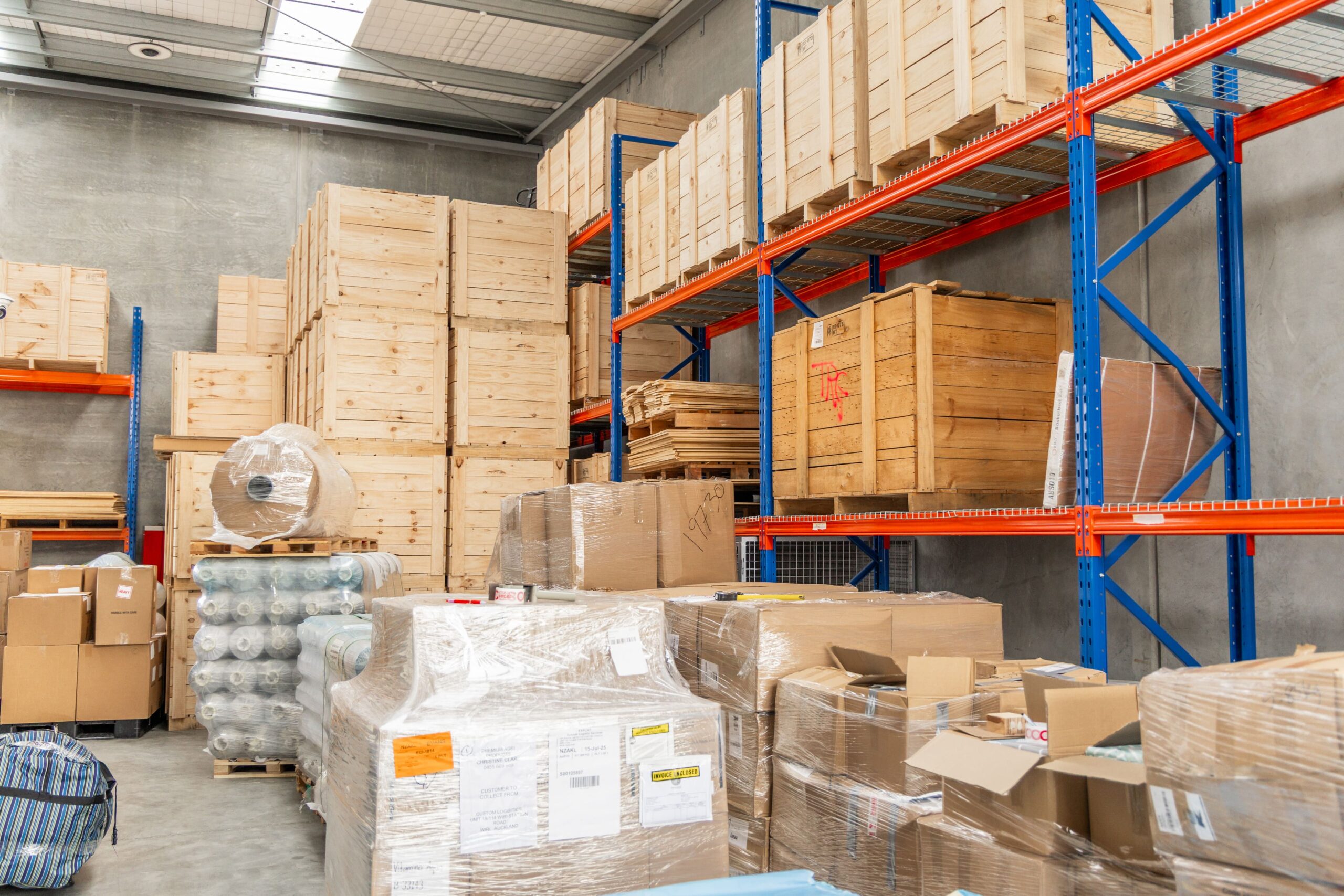 9002e0282cd26550bd83445f5ab0b779ff6cccee-min Stacked Boxes inside warehouse